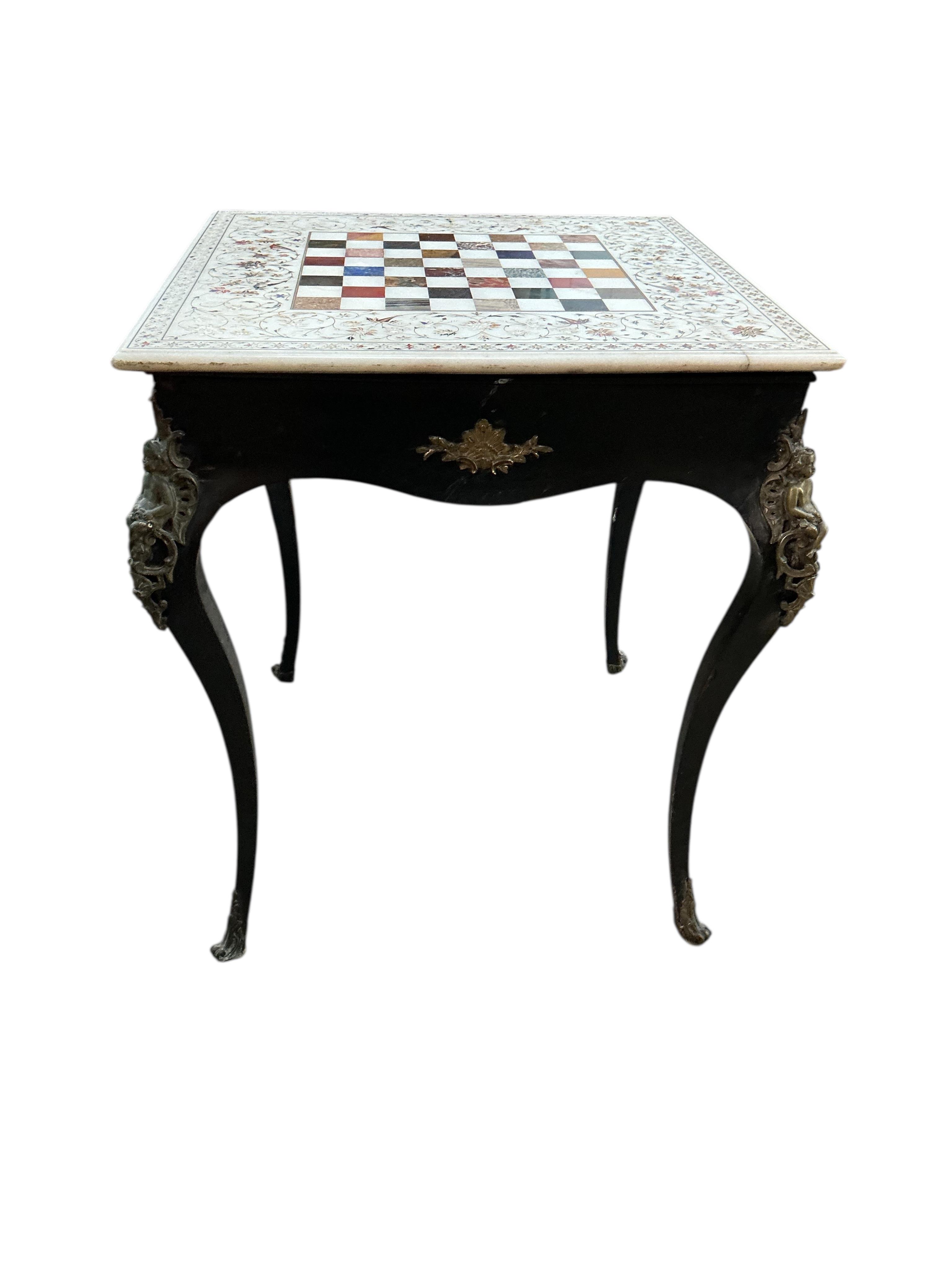 An Indian specimen marble chess set on an earlier associated gilt metal ebonised stand, width 68cm, height 74cm